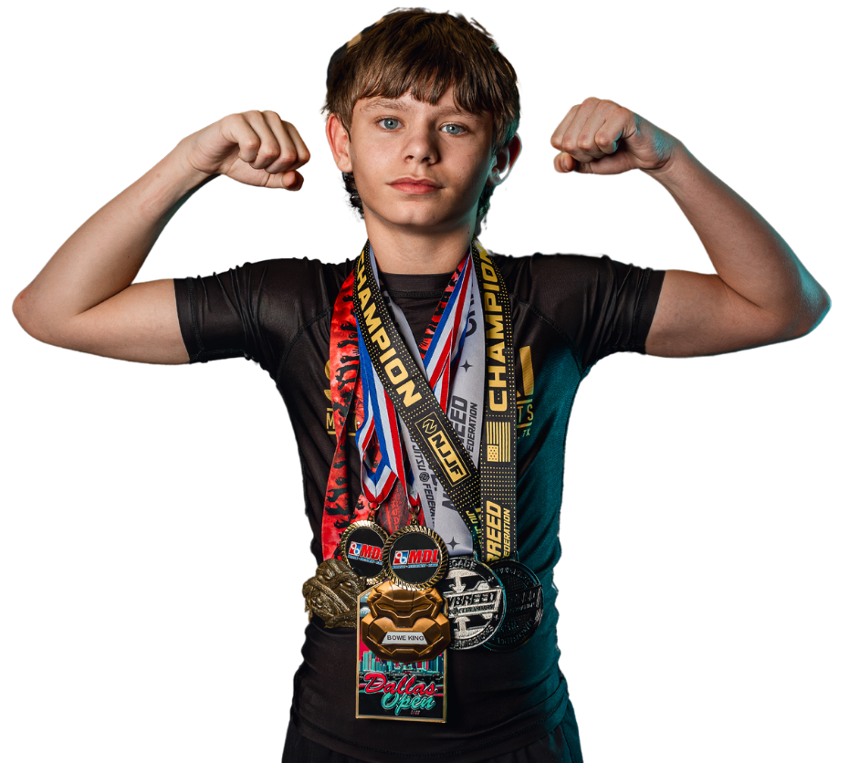 A young boy proudly flexing his muscles