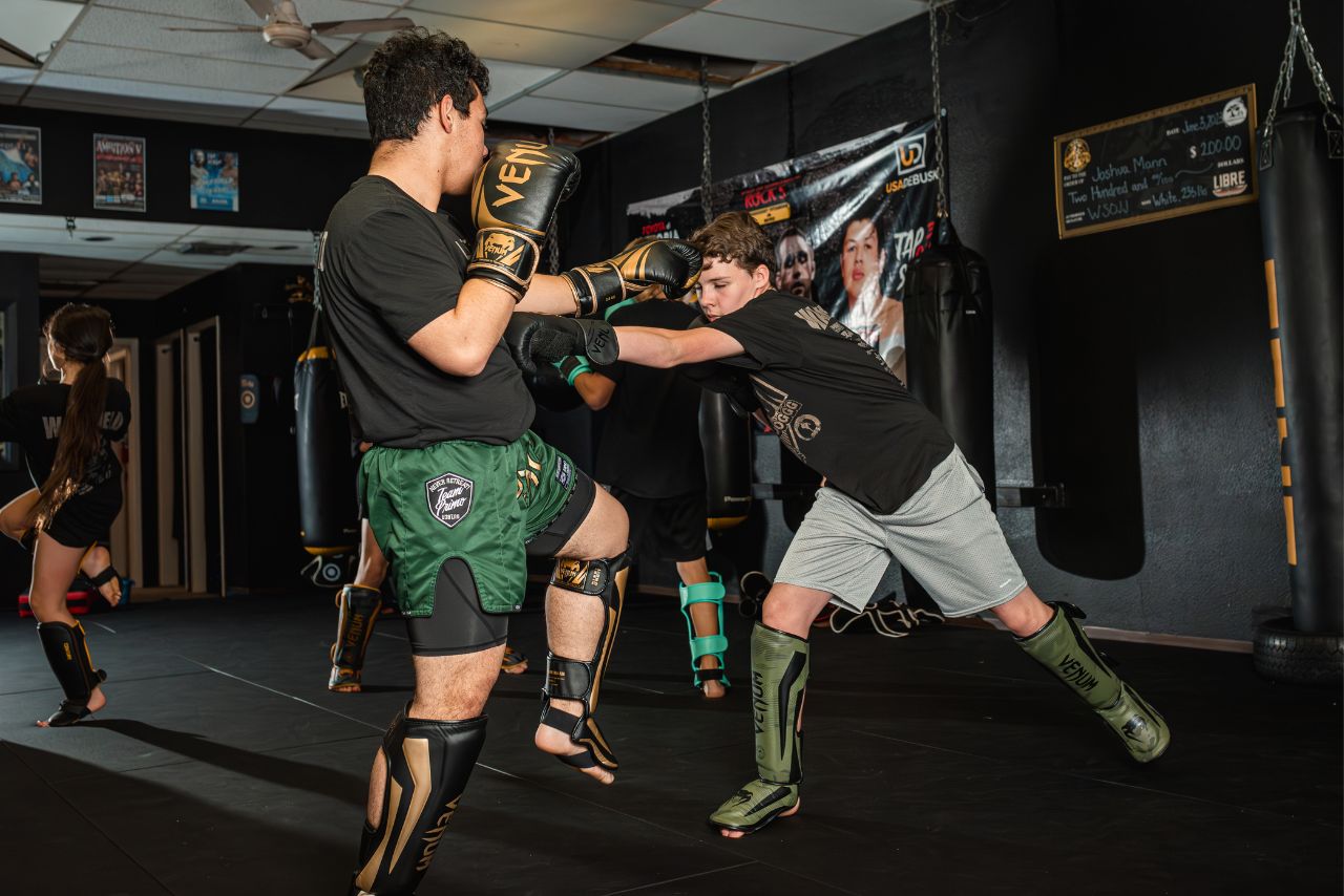 Two men practicing martial arts in a gym